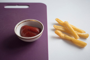 top view of french fries with ketchup on plate