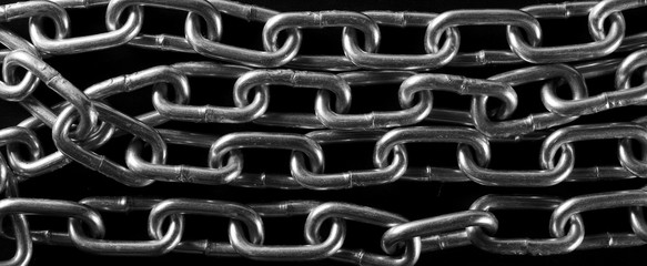 Metal chain on black background and texture