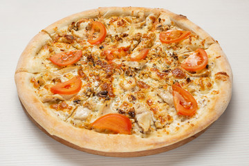 Italian pizza with chicken, walnuts and tomatoes, with white sauce