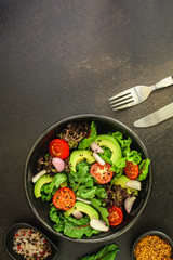 healthy salad avocado, vegetables, mix leaves, salad dressing (tasty and healthy food) menu concept. food background. copy space. Top view