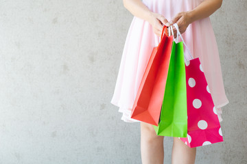 Close up of woman hand holding shopping bags.