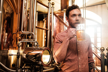 Man tasting fresh beer in a brewery