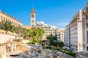 Obraz premium Roman baths ancient ruins site, modern buidings and Saint Louis Cathedral of the Capuchin Fathers Latin Catholic church in the downtown of Beirut, Lebanon
