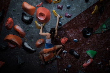 Athletic woman practicing in a bouldering gym © Nejron Photo