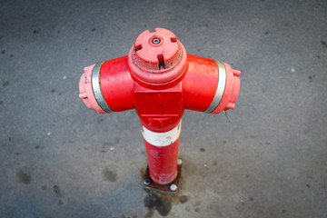 Red fire hydrant against grey side walk