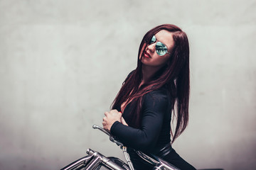 Fototapeta na wymiar close up. female biker standing near a blank screen in the club