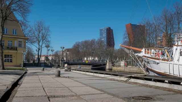 Timelapse of people and transport rush across Birzos tiltas Exchange bridge over Dane river in Klaipeda, Lithuania