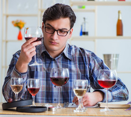 Professional sommelier tasting red wine