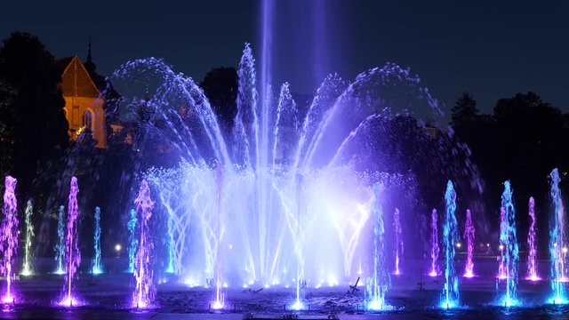 Fountain illuminated at night in city park in Warsaw, Poland