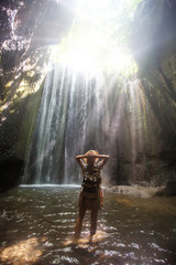 Woman near waterfal on Bali, Indonesia 
