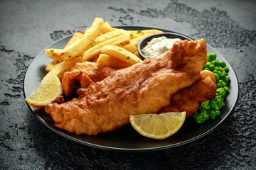 British Traditional Fish and chips with mashed peas, tartar sauce and cold beer. - obrazy, fototapety, plakaty