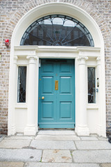 Fototapeta na wymiar A blue door in Dublin, Ireland. Arched Georgian door house front