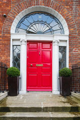 A red door in Dublin, Ireland. Arched Georgian door house front