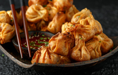 Chinese takeaway finger food Vegetable wontons with sweet chilli dip sauce and chop sticks