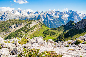 Man climbing on a mountain peak in the Italian Dolomites