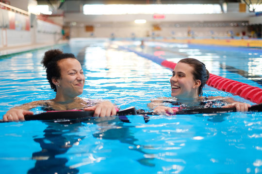 Multiracial couple attending water aerobics class in a swimming pool