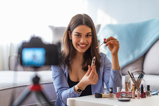 Happy Smiling Woman Or Beauty Blogger With Bronzer, Brush And Camera Recording Tutorial Video At Home.