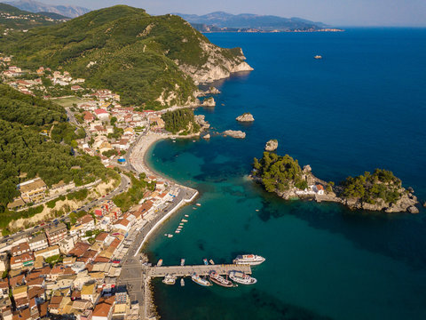 Parga Greece drone aerial view. Crystal water natural landscape and beautiful architectural buildings near the port of Parga Epirus, Greece, Europe. © umike_foto