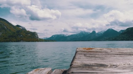 Wooden Pier on the Background of a Mountain Lake and Snowy Alps. Austria. Wolfgangsee Lake