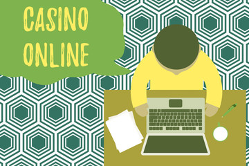 Text sign showing Casino Online. Business photo showcasing Computer Poker Game Gamble Royal Bet Lotto High Stakes Upper view young man sitting working table laptop documents coffee cup pen