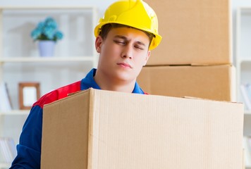 Young man working in relocation services with boxes