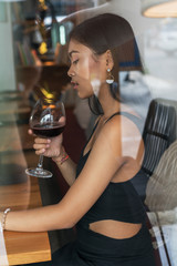 Asian girl  in a cafe. Beautiful Balinese women with glass of wine