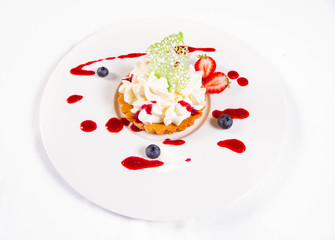 Tartlet with cream decorated with berry fruit