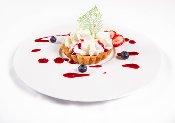 Tartlet with cream decorated with berry fruit