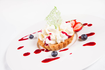 Tartlet with cream decorated with berry fruit