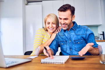Fototapeta premium Happy couple managing home finances