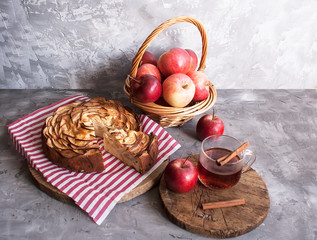 Traditional Apple pie with cinnamon and hot tea on the table