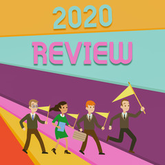 Handwriting text writing 2020 Review. Conceptual photo seeing important events or actions that made previous year People Crowd Flags Pennants Headed by Leader Running Demonstration Meeting