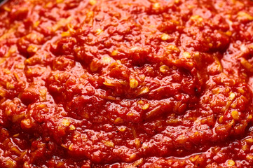 Schezwan Sauce close up texture. Schezwan Sauce is Indo-chinese or Sichuan cuisine hot sauce with red chilli, garlic and ginger.