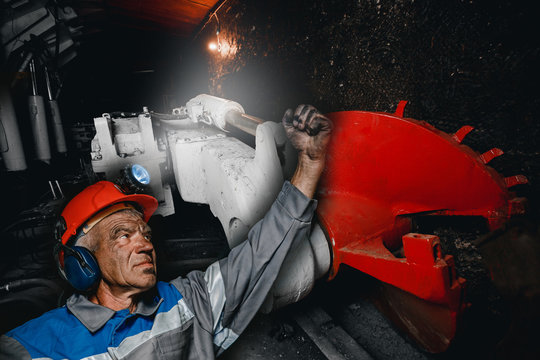 Miner man hands protest fist up revolution coal mine. Concept workers strike