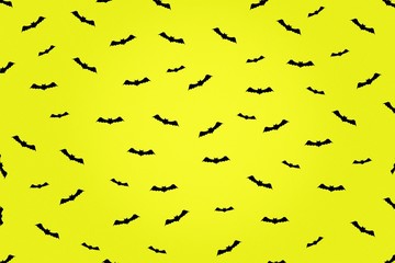 Happy Halloween background. A lot of bats icons on a yellow background. Festive background.