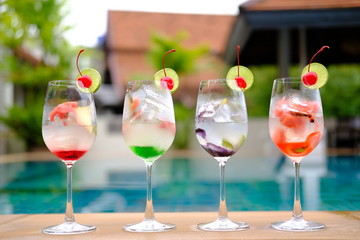 glasses of cocktails with strawberries and cream on white background