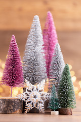 Colorful Christmas tree on wooden, bokeh background.