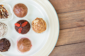 Several different sweet cupcakes on a white plate