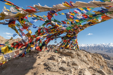 Colorful tibetan prayer flags on rock mountain in Leh Ladakh