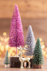 Colorful Christmas tree on wooden, bokeh background.