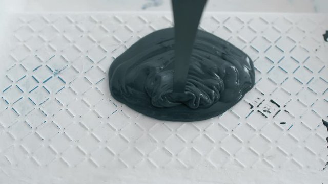 Black paint pouring in white paint for painting walls. Coloring paints for repair. 4k slow motion footage.