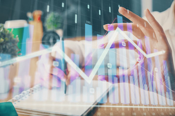 Forex chart displayed on woman's hand taking notes background. Concept of research. Multi exposure