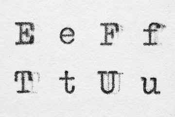 Real typewriter font alphabet with letters E, F, T, U