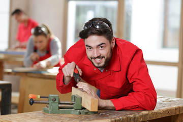 happy man spending time in his woodworking workshop