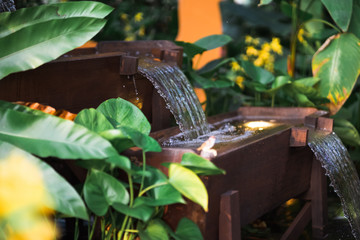 A cascading water feature in a tropical garden.