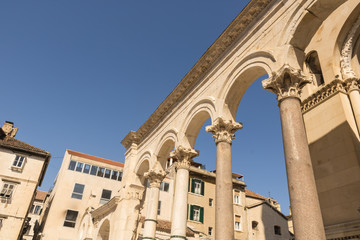 Fototapeta na wymiar Beautiful roman columns near the entrance of Cathedral of Saint Domnius with the blue sky and houses, Split, Croatia - Image