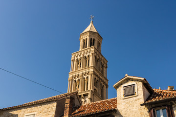 Fototapeta na wymiar Bell tower on the top of Cathedral of Saint Domnius with the blue sky and houses, Split, Croatia - Image