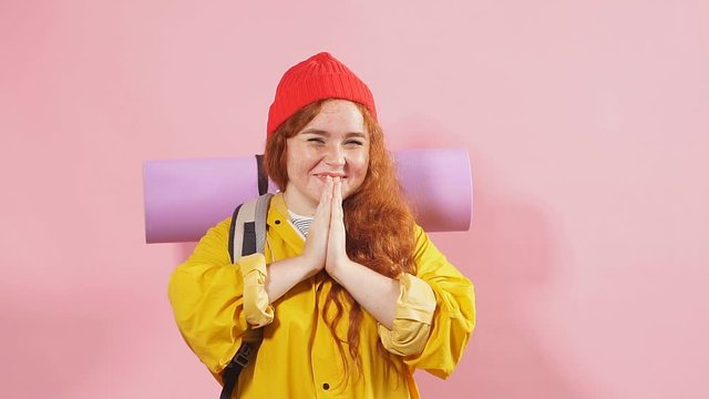 Attractive plump female traveler asking the direction. Can you help me. ginger girl with keeping palms together asking to stay overnight.