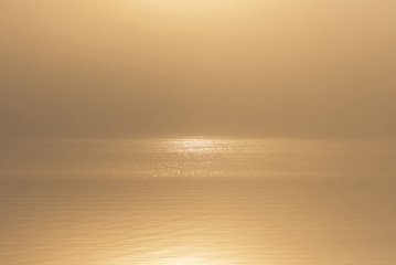 Fototapeta na wymiar Sunrise over a shimmering sea
