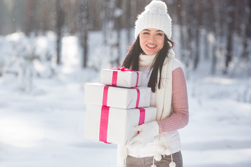Close up portrait of young beautiful woman holding Christmas presents